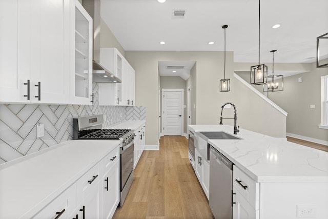 2206 Mansfield, Houston, TX 77091 - kitchen with stainless steel appliances, backsplash, recessed lighting, white cabinets, and light wood-style flooring