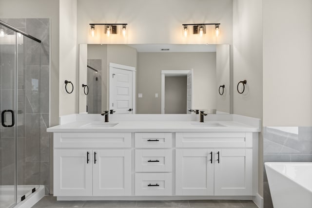 2206 Mansfield, Houston, TX 77091 - full bath with double vanity, a stall shower, and a freestanding tub