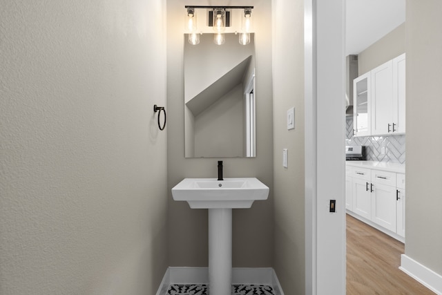 2206 Mansfield, Houston, TX 77091 - bathroom featuring backsplash and wood finished floors