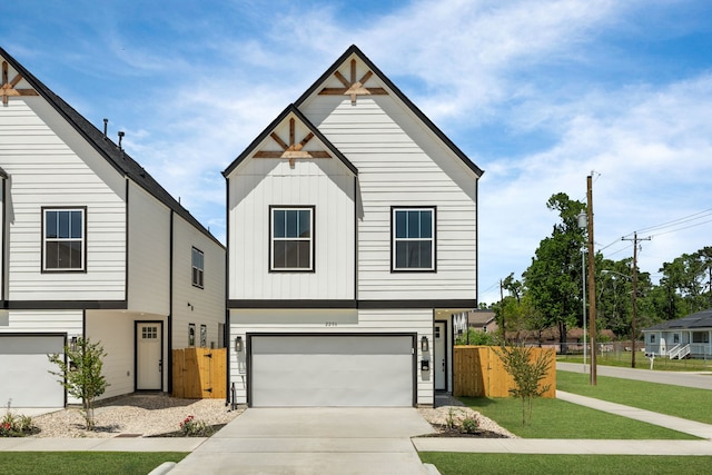 2206 Mansfield, Houston, TX 77091 - view of front of home featuring board and batten siding, a garage, and concrete driveway