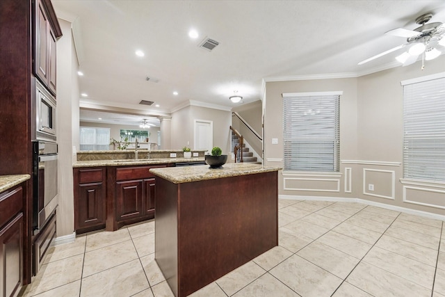 1339 Ella Pl, Houston, TX 77008 - kitchen featuring ceiling fan, crown molding, a center island, light tile patterned flooring, and recessed lighting