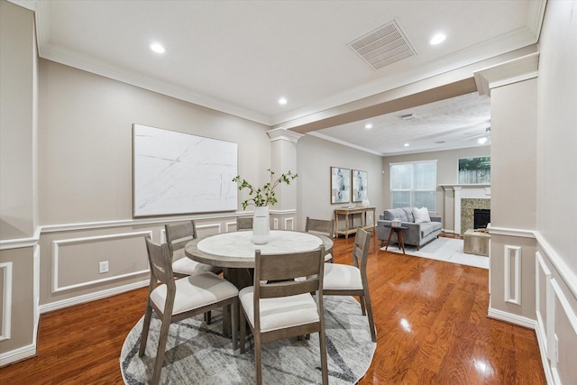 1339 Ella Pl, Houston, TX 77008 - dining room with crown molding, wood finished floors, recessed lighting, wainscoting, and a decorative wall