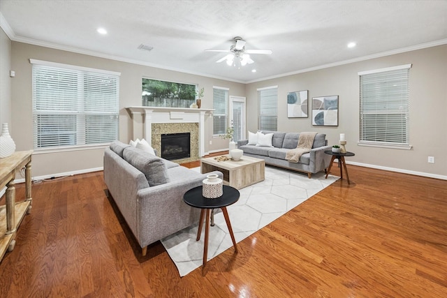 1339 Ella Pl, Houston, TX 77008 - living room with ceiling fan, wood finished floors, a tile fireplace, crown molding, and recessed lighting