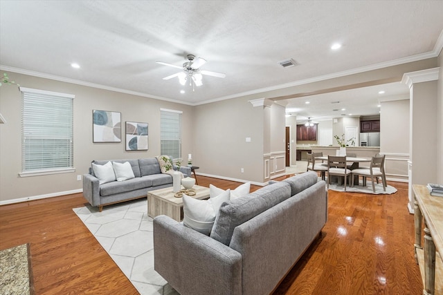 1339 Ella Pl, Houston, TX 77008 - living area featuring decorative columns, a ceiling fan, light wood-type flooring, crown molding, and recessed lighting