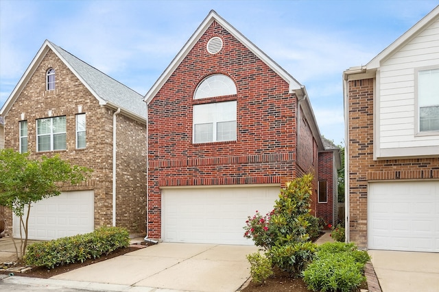 1339 Ella Pl, Houston, TX 77008 - view of front of house featuring a garage, brick siding, and concrete driveway