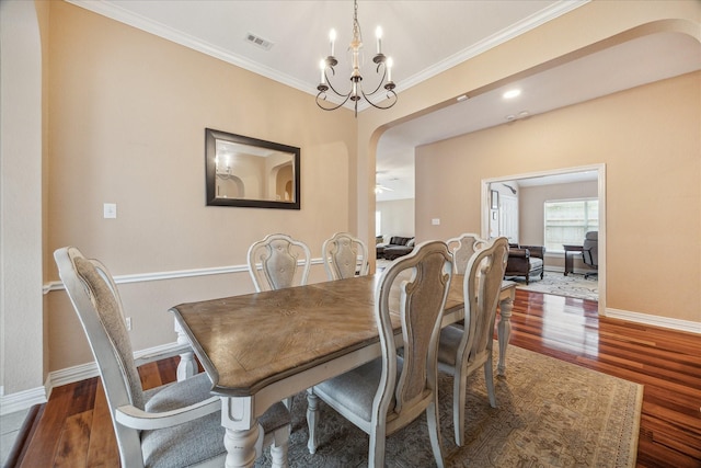 7206 Broadelm Dr, Houston, TX 77095 - dining room featuring arched walkways, wood finished floors, ornamental molding, and a chandelier