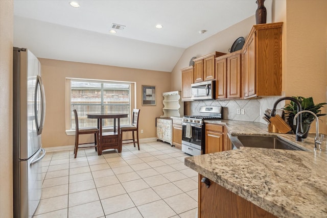 7206 Broadelm Dr, Houston, TX 77095 - kitchen featuring appliances with stainless steel finishes, lofted ceiling, decorative backsplash, light tile patterned flooring, and recessed lighting