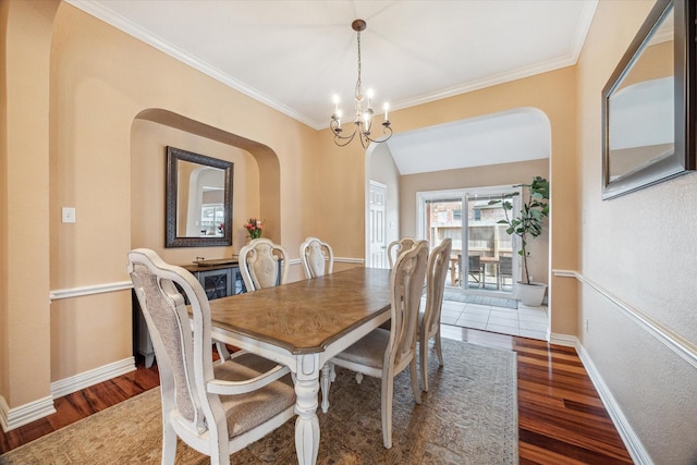 7206 Broadelm Dr, Houston, TX 77095 - dining space featuring arched walkways, wood finished floors, a chandelier, and ornamental molding