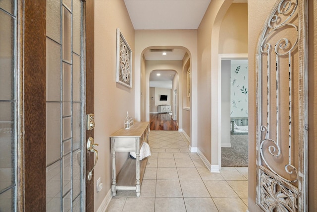 7206 Broadelm Dr, Houston, TX 77095 - foyer with arched walkways, light tile patterned flooring, and recessed lighting