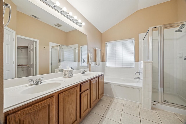 7206 Broadelm Dr, Houston, TX 77095 - full bathroom featuring a shower stall, double vanity, vaulted ceiling, tile patterned floors, and a garden tub