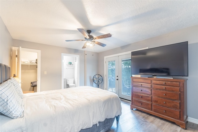 503 Detering St, Houston, TX 77007 - bedroom featuring access to outside, wood finished floors, a ceiling fan, french doors, and a spacious closet