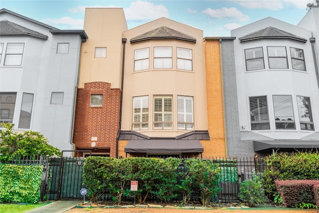 503 Detering St, Houston, TX 77007 - view of front of property featuring brick siding, stucco siding, and a gate