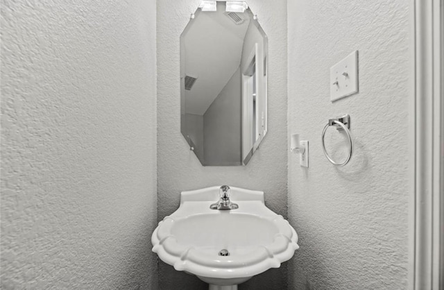 8814 Silent Willow Ln, Sugar Land, TX 77479 - bathroom with a textured wall and a sink