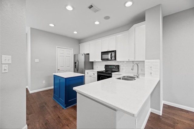 8814 Silent Willow Ln, Sugar Land, TX 77479 - kitchen with black appliances, a kitchen island, white cabinetry, dark wood-type flooring, and recessed lighting