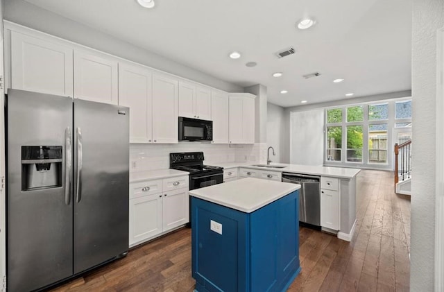 8814 Silent Willow Ln, Sugar Land, TX 77479 - kitchen featuring black appliances, a peninsula, white cabinets, dark wood finished floors, and recessed lighting