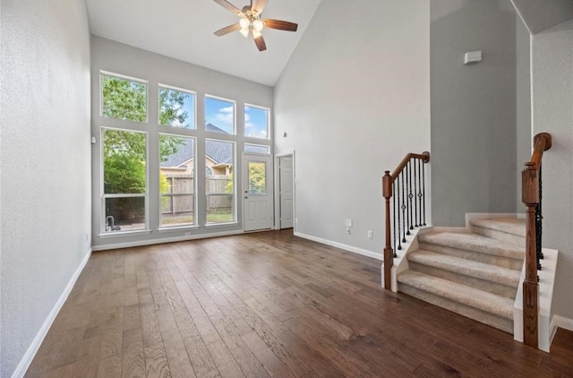 8814 Silent Willow Ln, Sugar Land, TX 77479 - unfurnished living room with a ceiling fan, high vaulted ceiling, hardwood / wood-style floors, stairs, and a textured wall