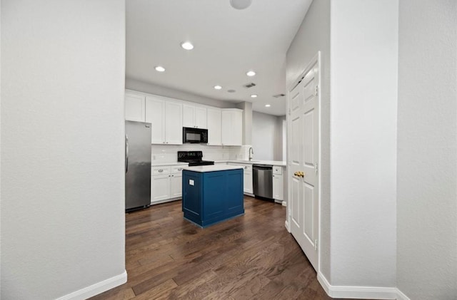 8814 Silent Willow Ln, Sugar Land, TX 77479 - kitchen with black appliances, white cabinetry, a kitchen island, dark wood-type flooring, and recessed lighting