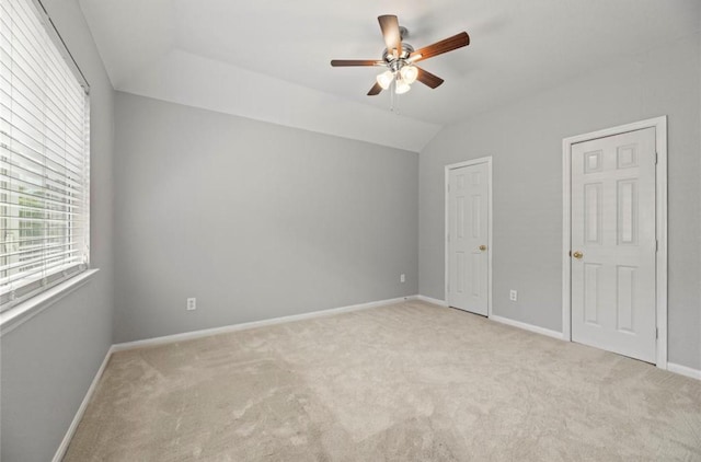 8814 Silent Willow Ln, Sugar Land, TX 77479 - unfurnished bedroom with light carpet, vaulted ceiling, and ceiling fan