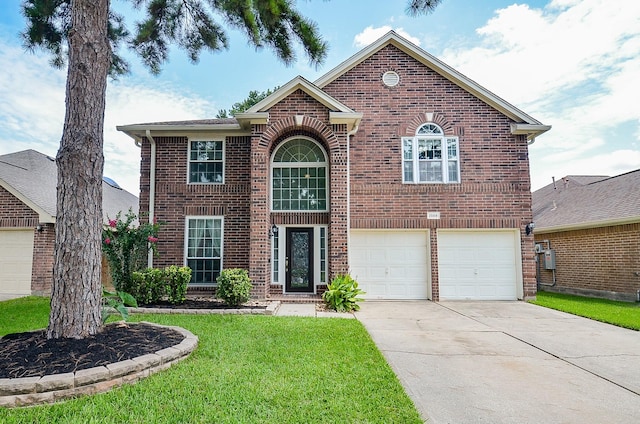 15018 Moss Boulder Ct, Houston, TX 77084 - traditional-style home with brick siding, an attached garage, a front lawn, and concrete driveway