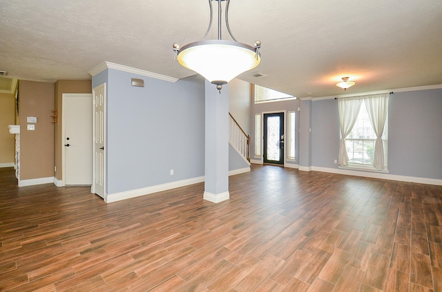 15018 Moss Boulder Ct, Houston, TX 77084 - unfurnished living room with wood finished floors, crown molding, stairs, and a textured ceiling