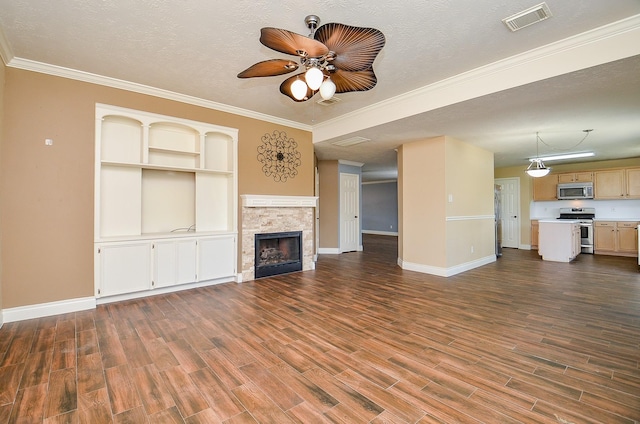 15018 Moss Boulder Ct, Houston, TX 77084 - unfurnished living room featuring a ceiling fan, dark wood-style flooring, a fireplace, ornamental molding, and a textured ceiling