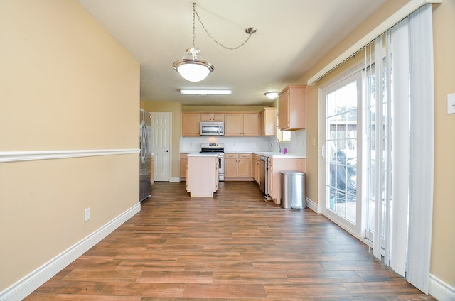 15018 Moss Boulder Ct, Houston, TX 77084 - kitchen featuring appliances with stainless steel finishes, light brown cabinetry, wood finished floors, light countertops, and a kitchen island