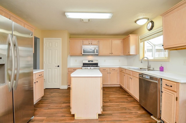 15018 Moss Boulder Ct, Houston, TX 77084 - kitchen featuring stainless steel appliances, light brown cabinetry, dark wood-style floors, a kitchen island, and light countertops