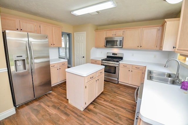 15018 Moss Boulder Ct, Houston, TX 77084 - kitchen with appliances with stainless steel finishes, light brown cabinets, a center island, and light countertops