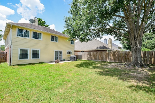 15018 Moss Boulder Ct, Houston, TX 77084 - back of house with a fenced backyard, a patio area, and a chimney