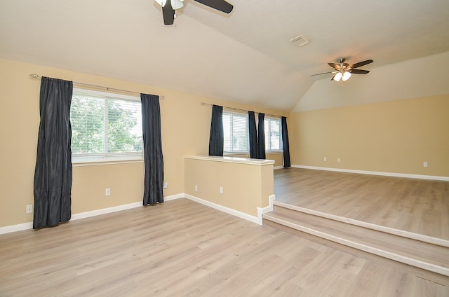 15018 Moss Boulder Ct, Houston, TX 77084 - empty room featuring ceiling fan, plenty of natural light, lofted ceiling, and light wood-style floors