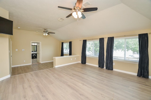 15018 Moss Boulder Ct, Houston, TX 77084 - unfurnished living room featuring ceiling fan, lofted ceiling, and light wood-style floors