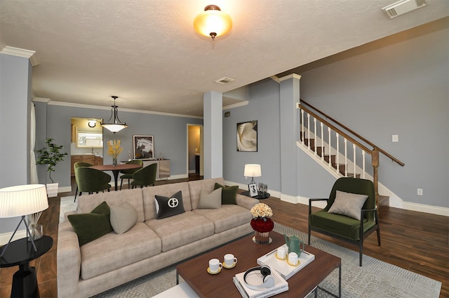 15018 Moss Boulder Ct, Houston, TX 77084 - living area featuring a textured ceiling, wood finished floors, stairs, and ornamental molding