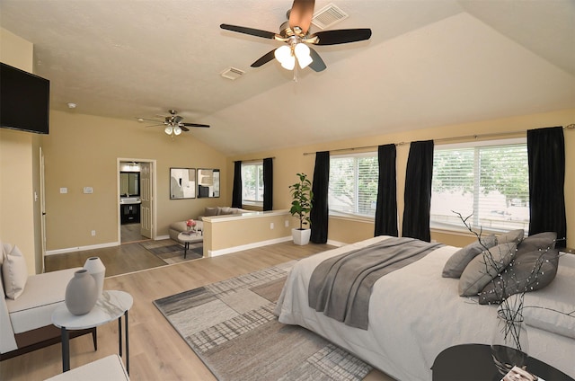 15018 Moss Boulder Ct, Houston, TX 77084 - bedroom featuring vaulted ceiling, wood finished floors, a ceiling fan, and ensuite bathroom