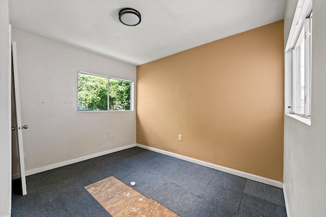 1922 Des Jardines St, Houston, TX 77023 - spare room featuring baseboards and carpet