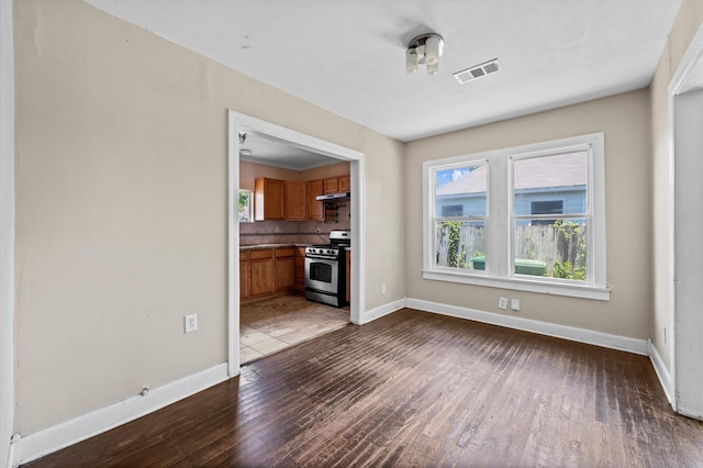 1922 Des Jardines St, Houston, TX 77023 - unfurnished living room with dark wood-style flooring and plenty of natural light