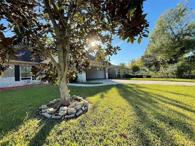 4106 Friar Point Rd, Houston, TX 77047 - view of front of house featuring concrete driveway, a front yard, and a garage