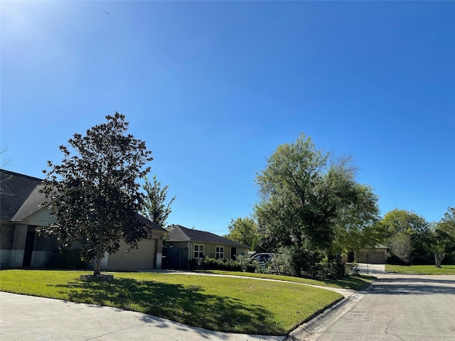 4106 Friar Point Rd, Houston, TX 77047 - view of front of house featuring driveway, a garage, and a front lawn