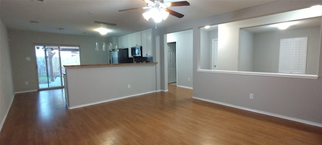 2518 Skyview Cove Ct, Houston, TX 77047 - kitchen with black microwave, freestanding refrigerator, wood finished floors, and ceiling fan
