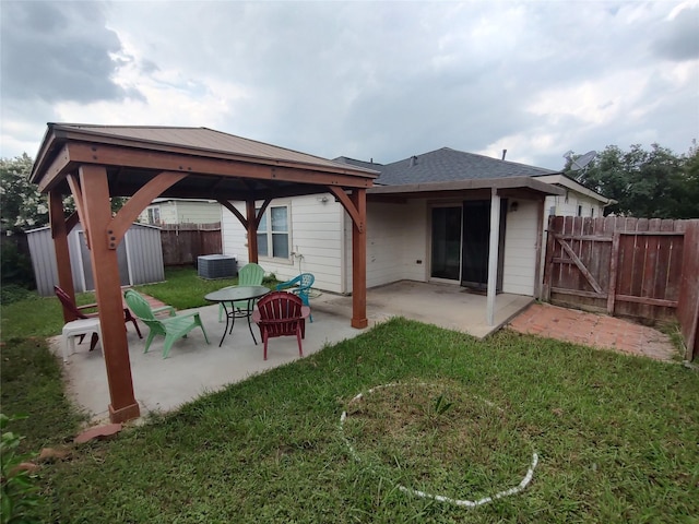 2518 Skyview Cove Ct, Houston, TX 77047 - rear view of house with a gazebo, a patio, a gate, and a storage shed