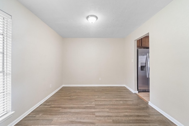 407 Gamewood Dr, Spring, TX 77386 - empty room featuring wood finished floors and a textured ceiling