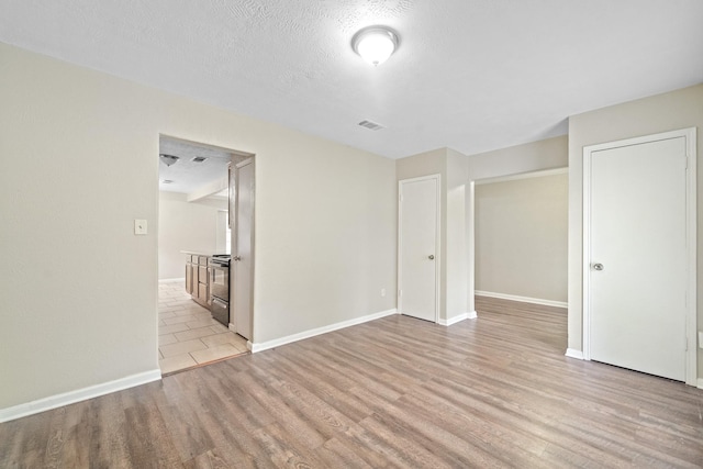 407 Gamewood Dr, Spring, TX 77386 - empty room with light wood-type flooring and a textured ceiling