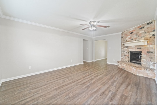 407 Gamewood Dr, Spring, TX 77386 - unfurnished living room featuring ceiling fan, wood finished floors, a fireplace, and crown molding