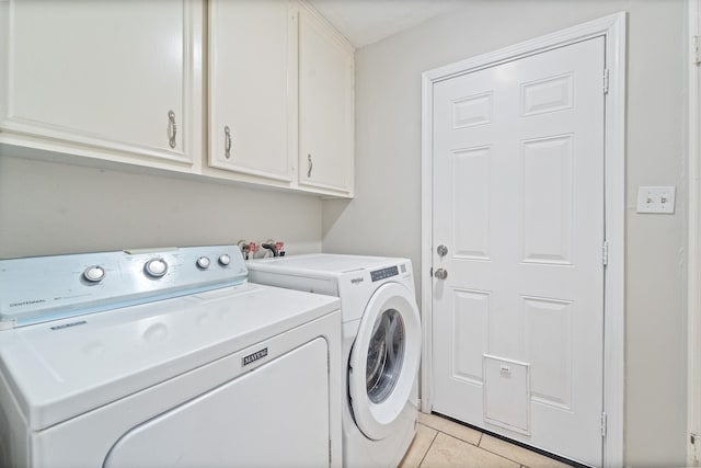407 Gamewood Dr, Spring, TX 77386 - laundry area with washer and clothes dryer, cabinet space, and light tile patterned floors