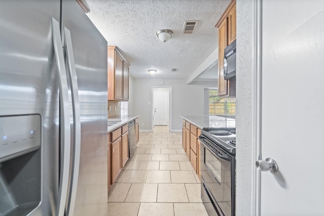 407 Gamewood Dr, Spring, TX 77386 - kitchen with black appliances, light stone countertops, a textured ceiling, and brown cabinetry