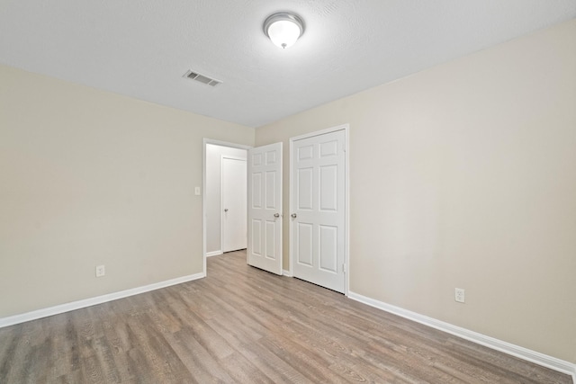 407 Gamewood Dr, Spring, TX 77386 - unfurnished bedroom featuring wood finished floors and baseboards