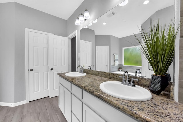 3534 Cork Dr, Houston, TX 77047 - bathroom with double vanity, wood finished floors, and a bathtub