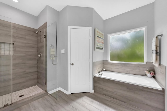 3534 Cork Dr, Houston, TX 77047 - full bath featuring a stall shower, a garden tub, and wood finished floors