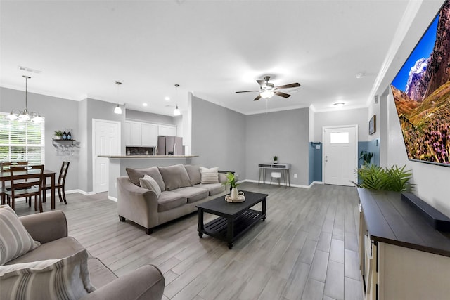 3534 Cork Dr, Houston, TX 77047 - living room with light wood-style floors, ceiling fan, ornamental molding, and a chandelier