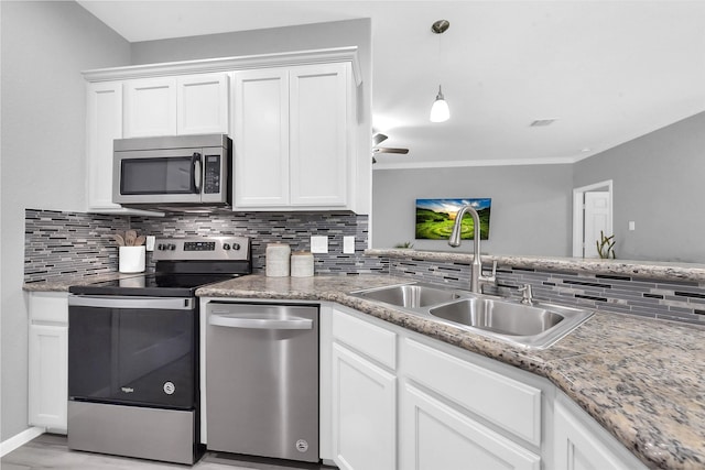 3534 Cork Dr, Houston, TX 77047 - kitchen featuring stainless steel appliances, tasteful backsplash, and white cabinetry