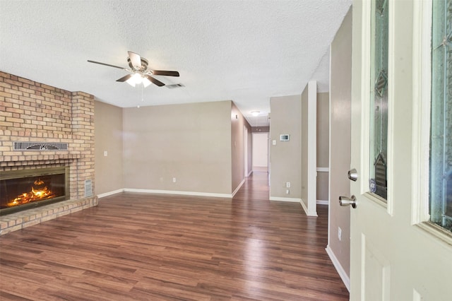 1002 Williams St, Cleveland, TX 77327 - unfurnished living room featuring wood finished floors, a ceiling fan, a fireplace, and a textured ceiling